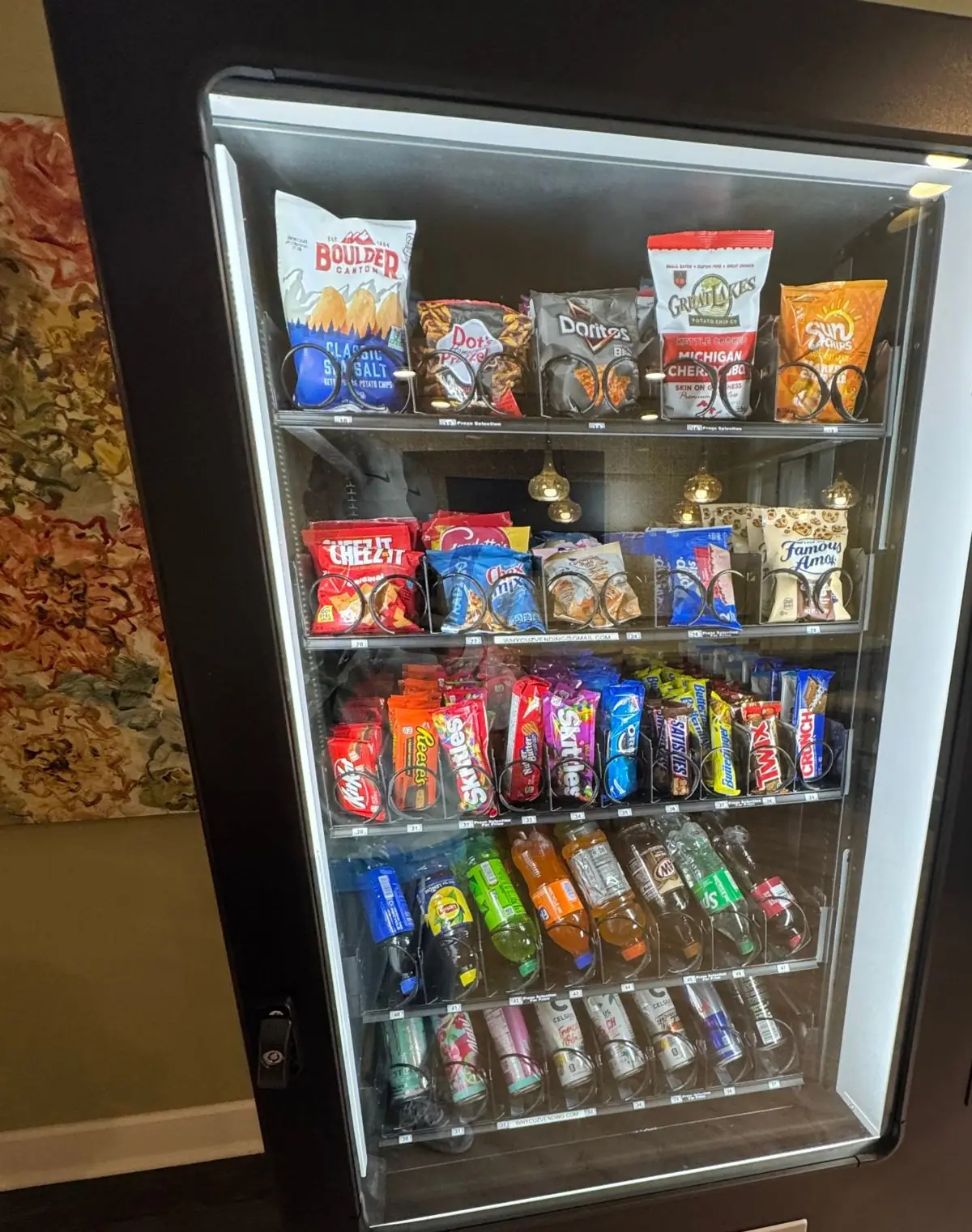 WhyCuz vending machine stocked with Michigan-made chips in an indoor lounge